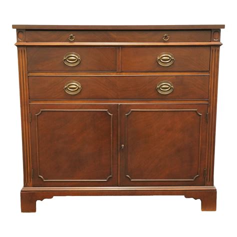 This piece features a rectangular top over a set of cabinet doors with brass hardware that open to interior storage. . Drexel buffet cabinet